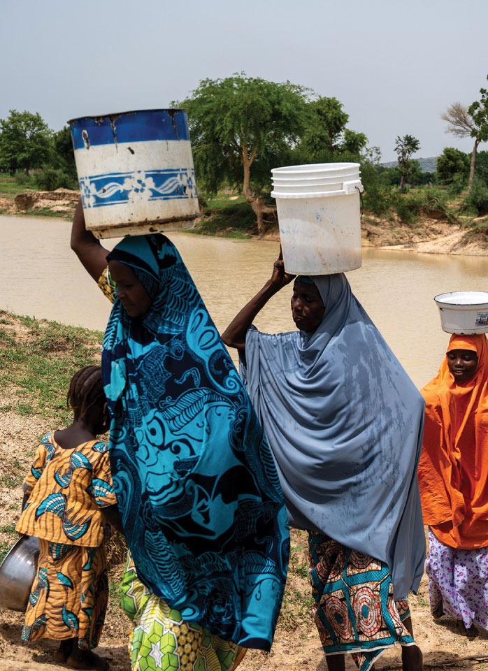 Rakiya from rural Nigeria sits quietly in her village. Unable to see from the Neglected Tropical Disease River Blindness, she must manage her daily chores on her own