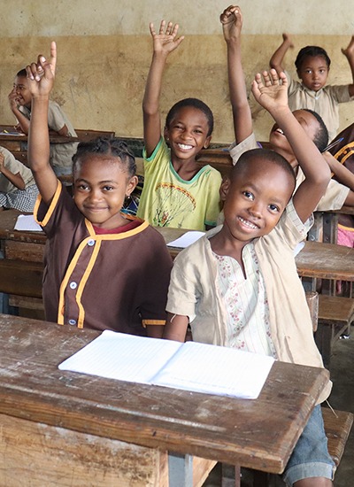 Happy children in the classroom at a cbm-partnered inclusive education school.]