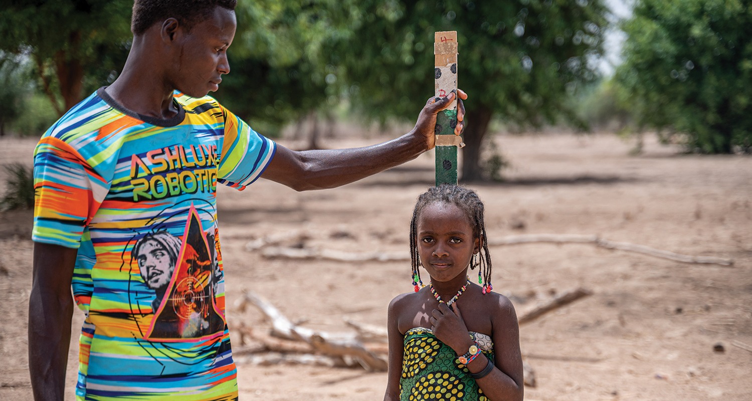 Isah helping protect Fatima from Neglected Tropical Diseases in Nigeria