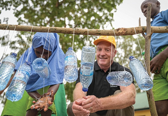 Murray Sheard in Nigeria using a WASH station at a rural primary school
