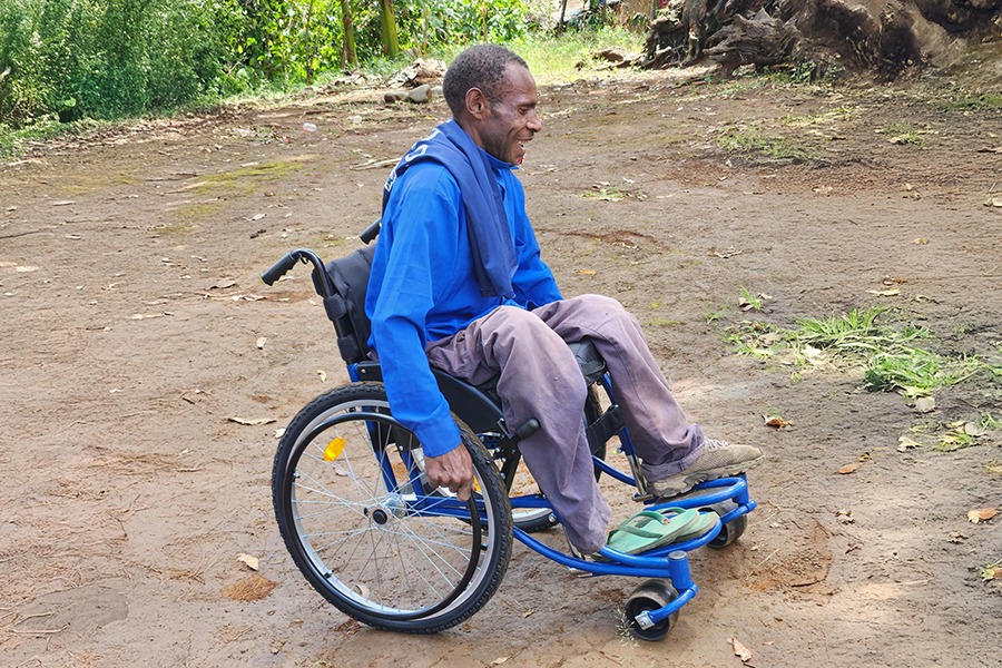 Samuel from Papua New Guinea with his new wheelchair